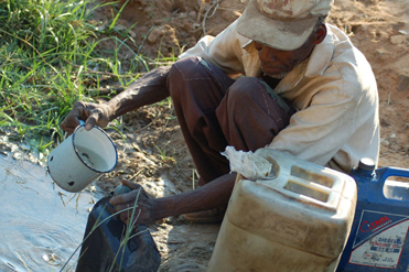 Water being collected from a stream.